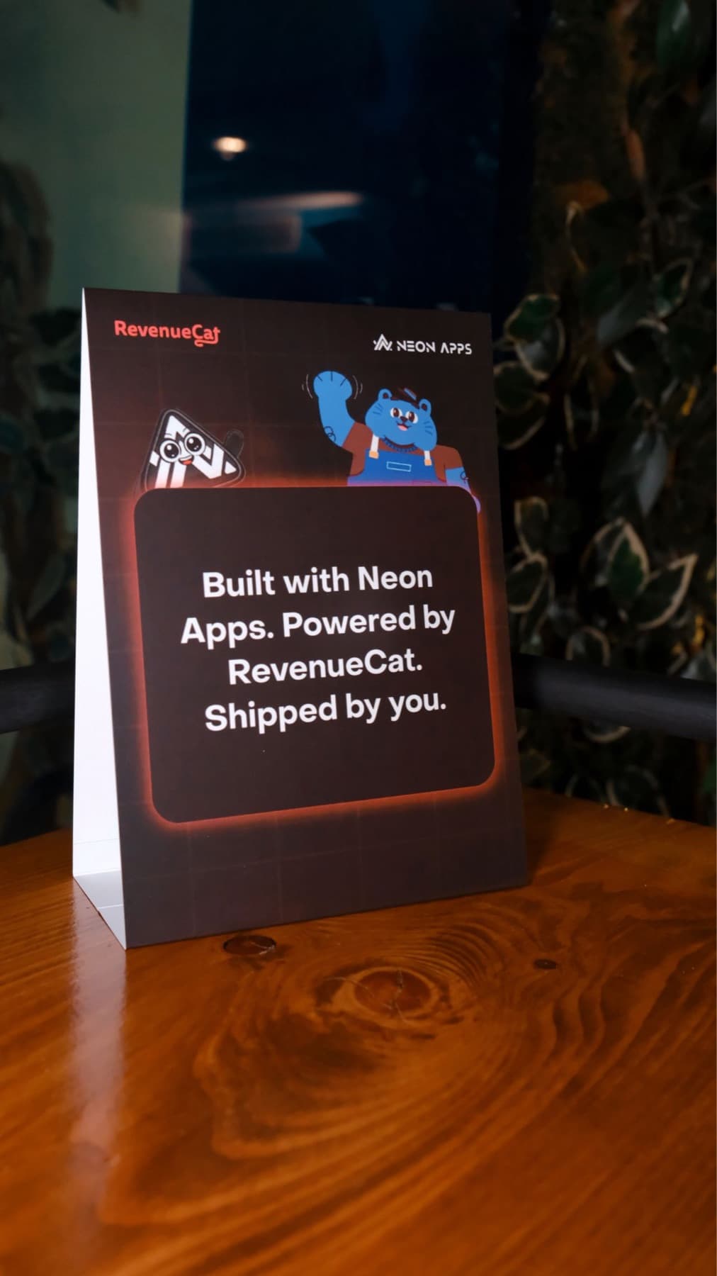 A RevenueCat and Neon Apps table card in the Istanbul office reading: Built with Neon Apps. Powered by RevenueCat. Shipped by you.