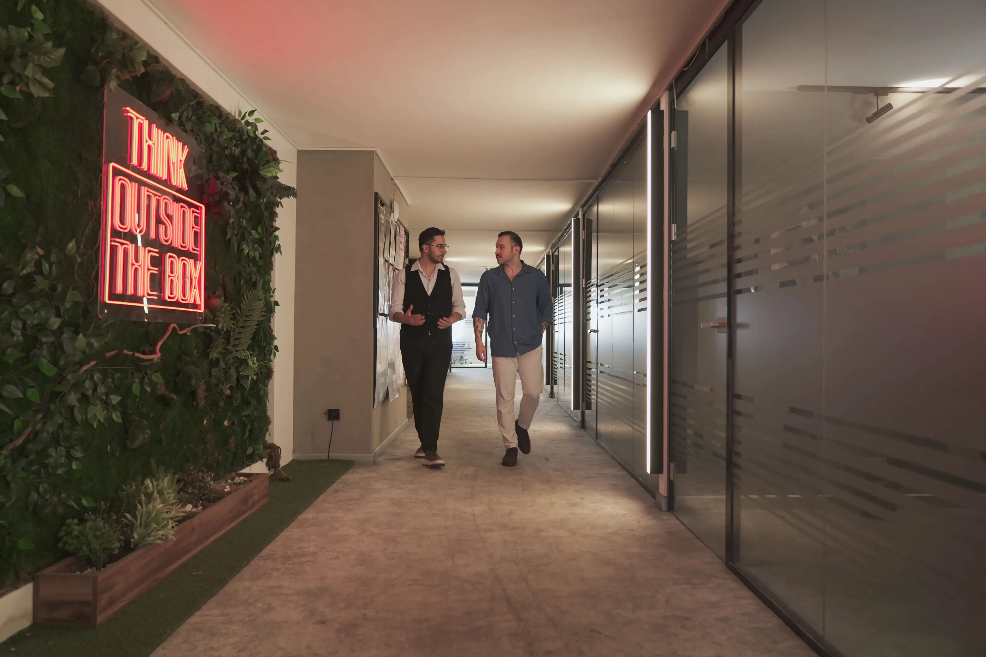 The corridor at the Istanbul office, neon sign on the plant wall