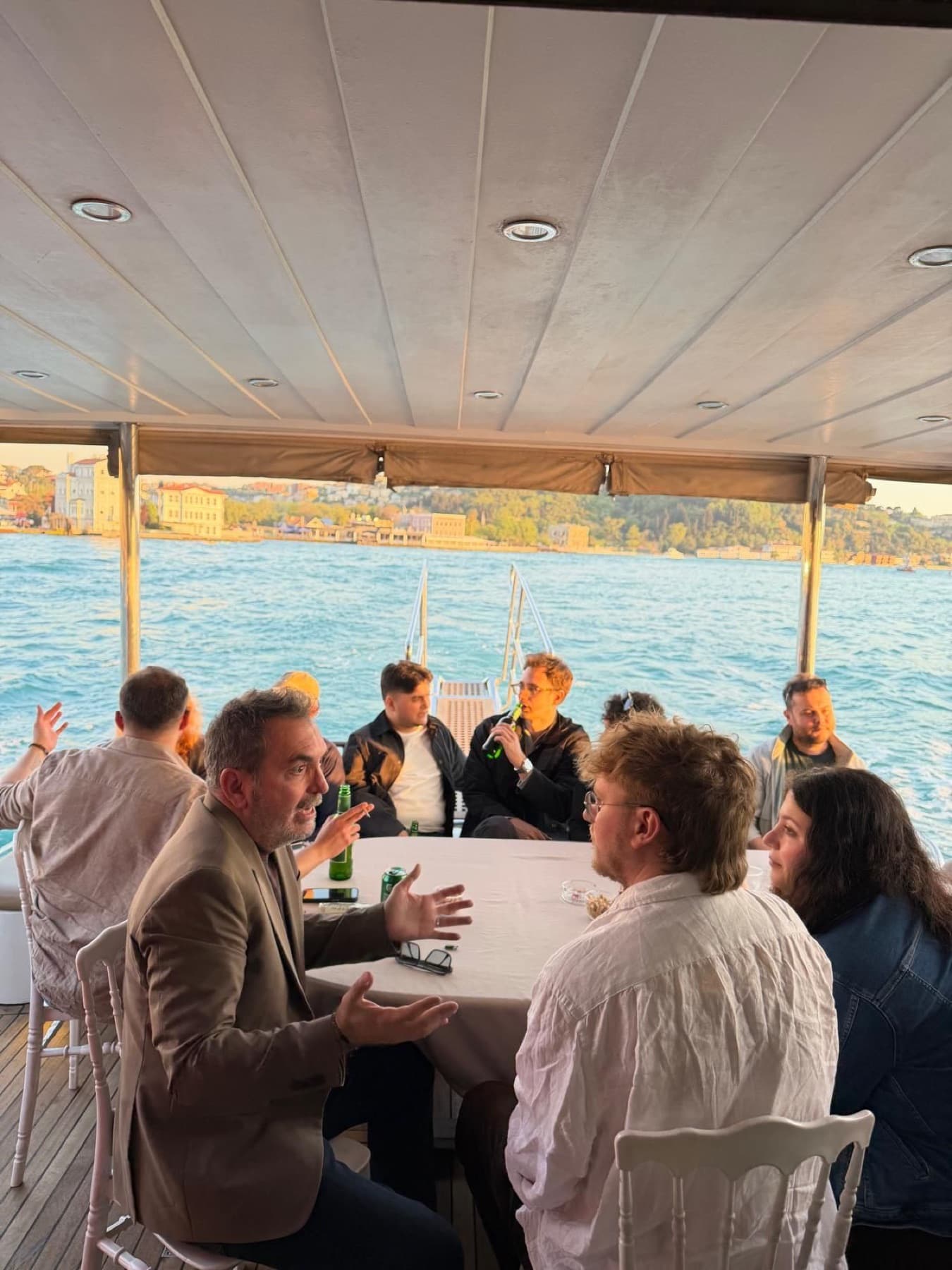App founders and investors talking around a table on the Bosphorus boat at the Neon Apps and RevenueCat meetup in Istanbul