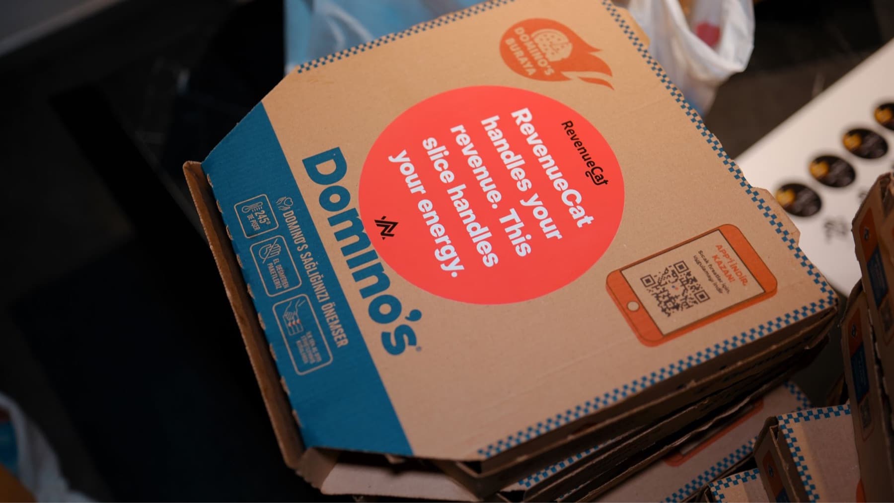 A Domino's pizza box with a RevenueCat and Neon Apps sticker at the App Founders New Year Party in the Istanbul office