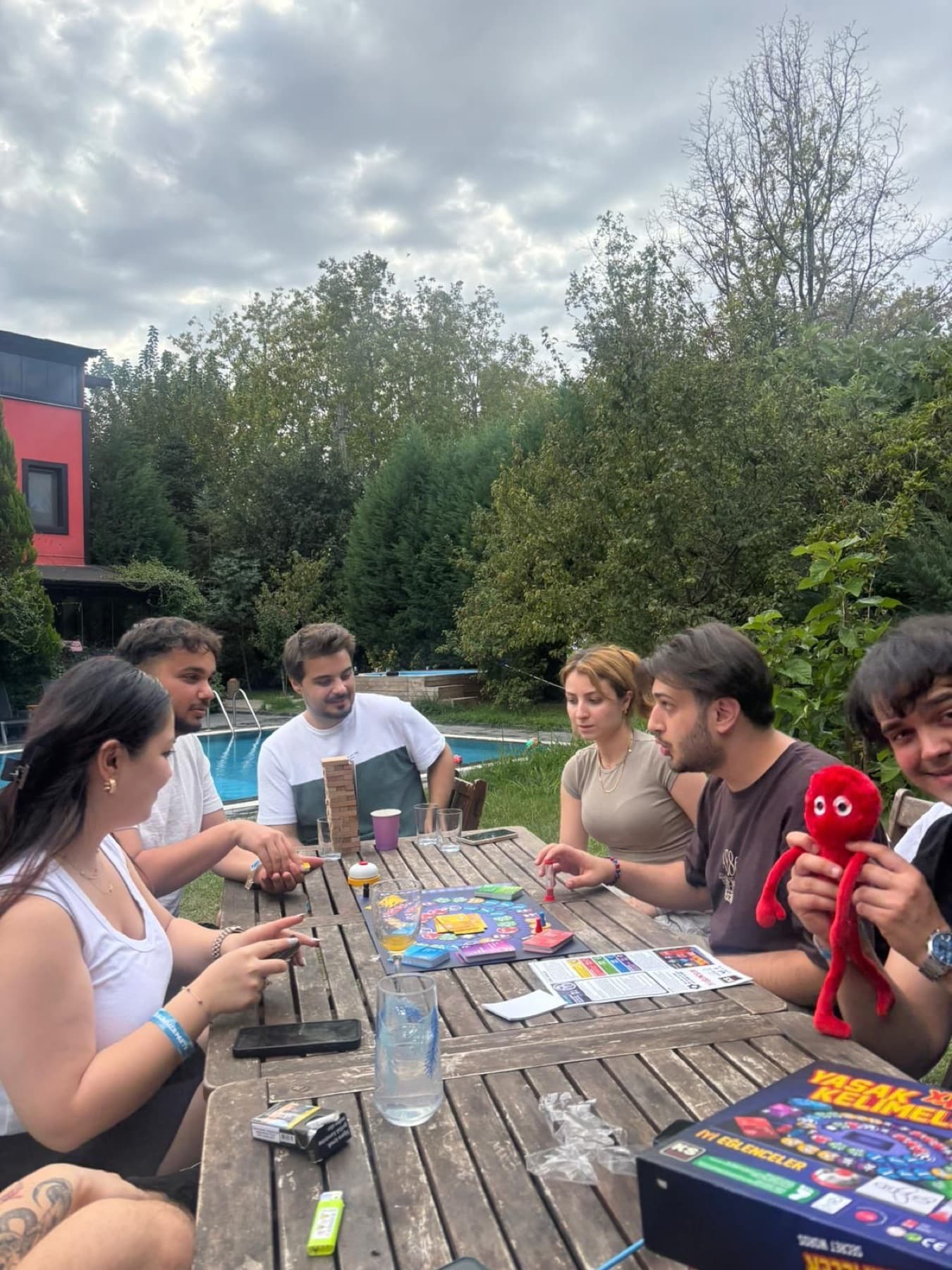 Neon Apps colleagues playing board games by the pool at the company summer party